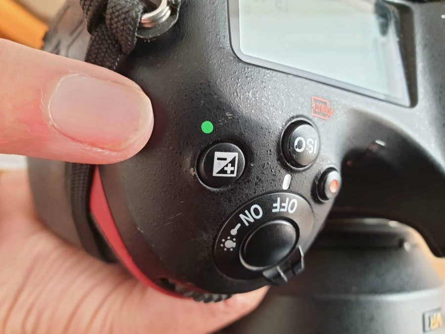 Het plus min knopje op je camera